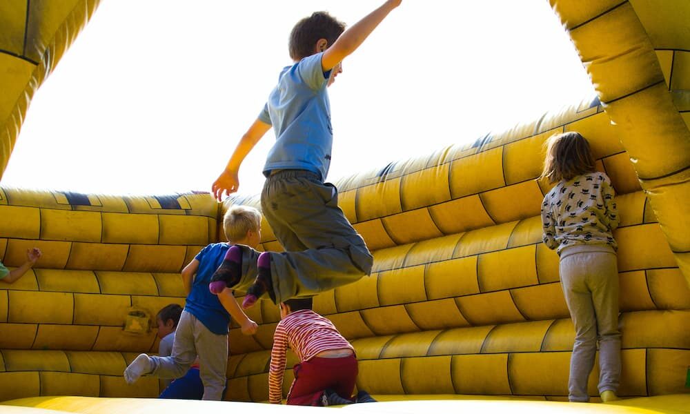 Children Playing on Inflatable Castle